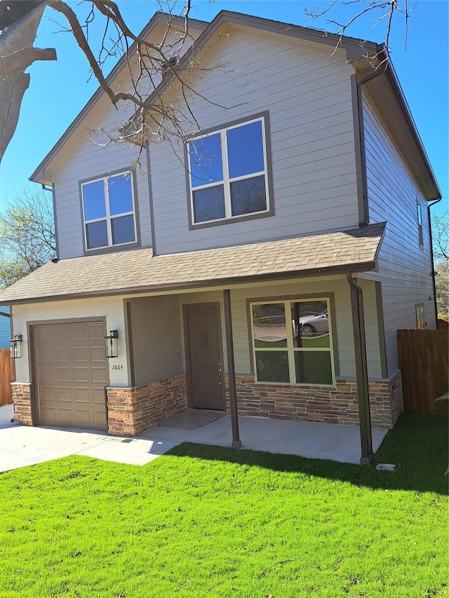 view of front of house with a garage and a front yard