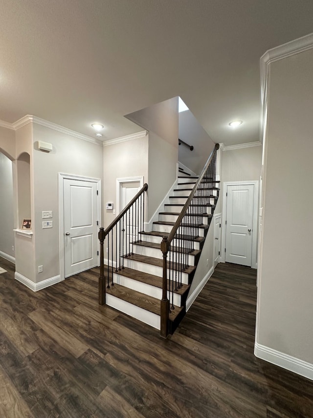 stairway featuring ornamental molding and hardwood / wood-style floors