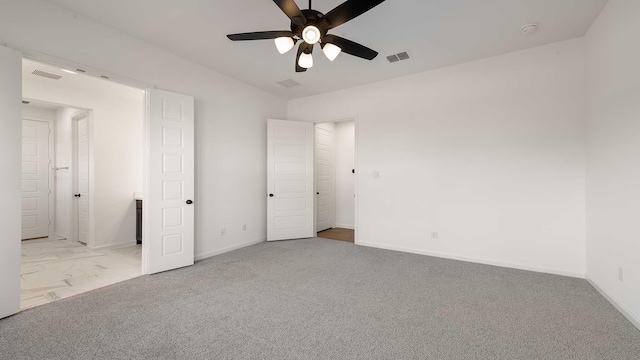 unfurnished bedroom featuring carpet flooring, visible vents, and baseboards