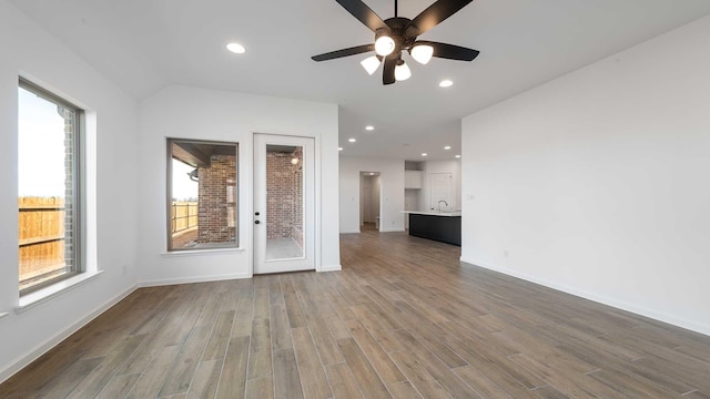 unfurnished room with recessed lighting, baseboards, and wood finished floors