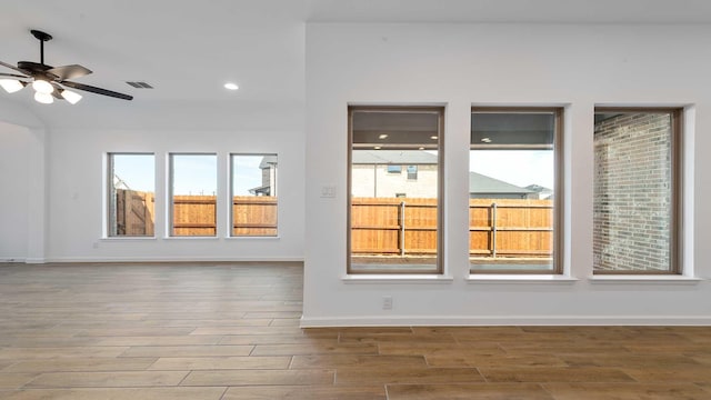 spare room featuring ceiling fan, baseboards, wood finished floors, and recessed lighting