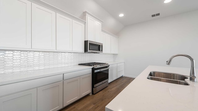 kitchen featuring light countertops, appliances with stainless steel finishes, backsplash, and a sink