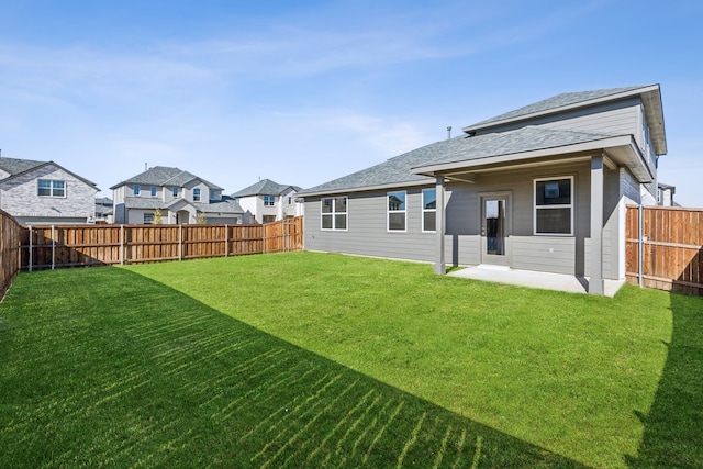 rear view of property with a yard