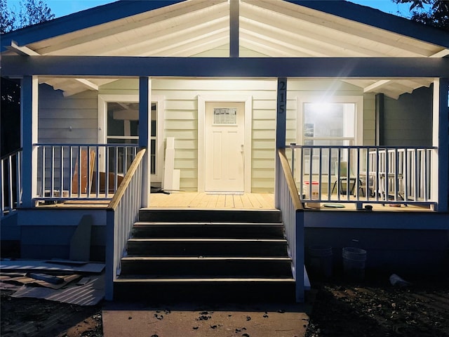 view of exterior entry with covered porch