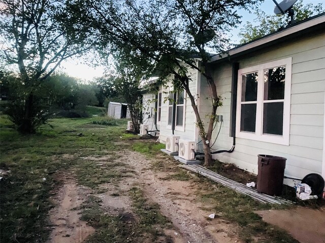 view of side of property with ac unit