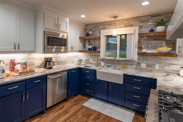 kitchen featuring tasteful backsplash, appliances with stainless steel finishes, sink, white cabinets, and blue cabinets