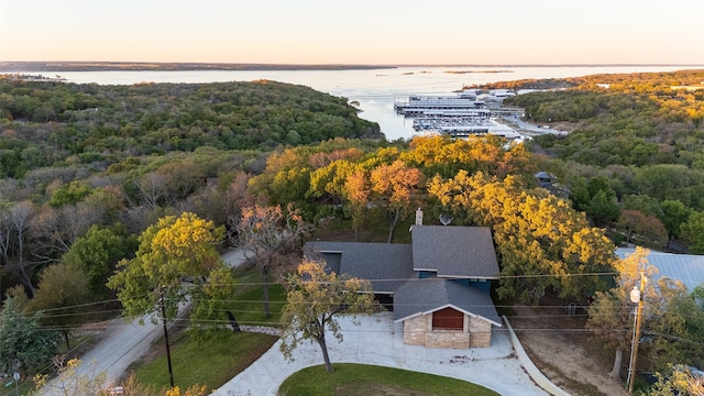 aerial view at dusk featuring a water view