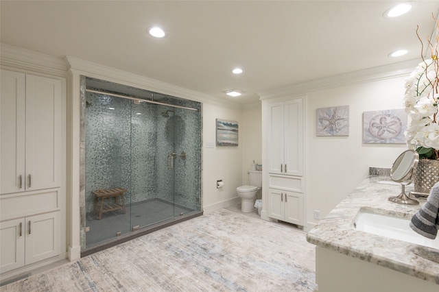 bathroom with ornamental molding, toilet, and a shower with shower door