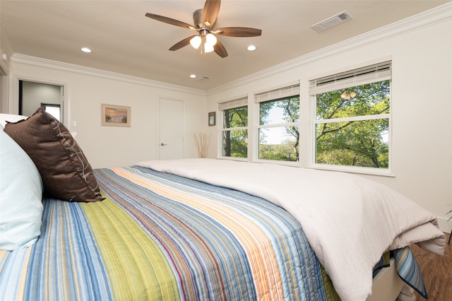 bedroom featuring ornamental molding and multiple windows