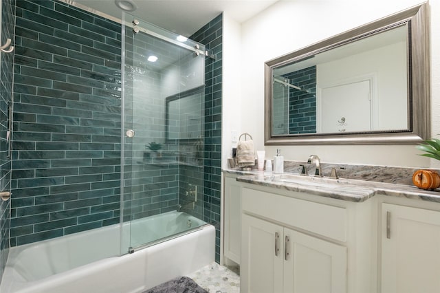 bathroom with shower / bath combination with glass door and vanity