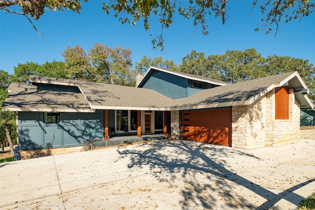 355 Lakecrest Dr, Pottsboro, TX 75076 - mid-century home featuring stone siding, driveway, covered porch, a garage, and roof with shingles