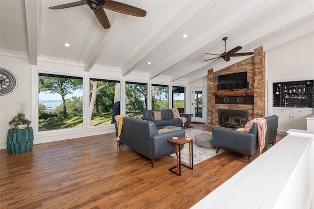 living room with a wealth of natural light, hardwood / wood-style flooring, and ceiling fan