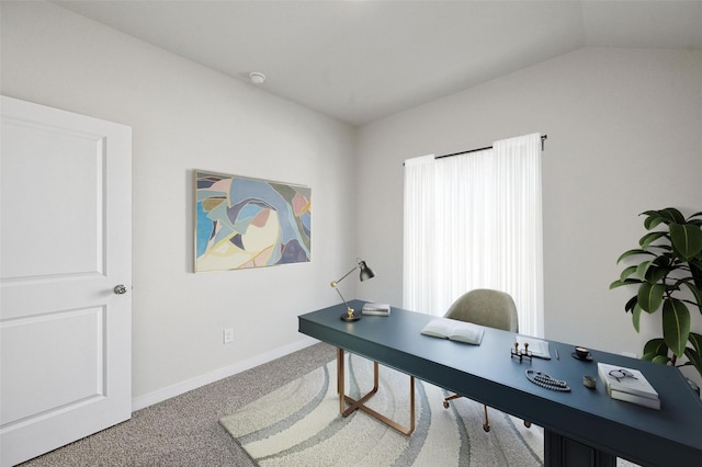 home office with lofted ceiling and carpet floors