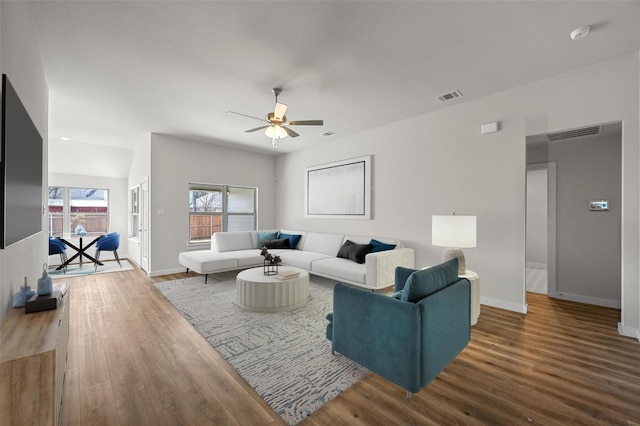 living room featuring hardwood / wood-style flooring and ceiling fan