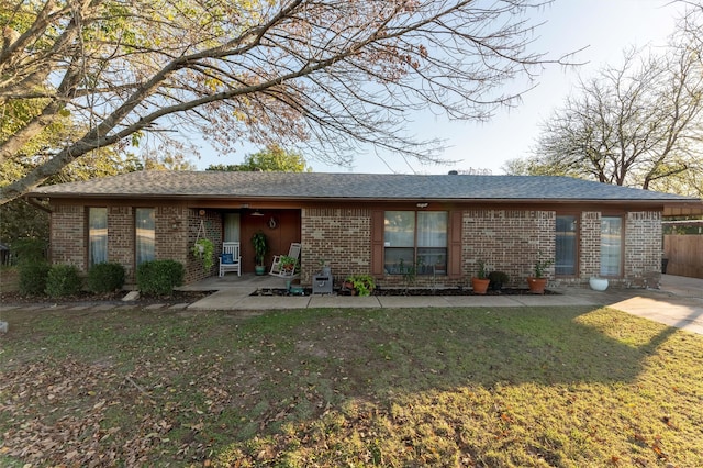 back of house with a lawn and a patio area