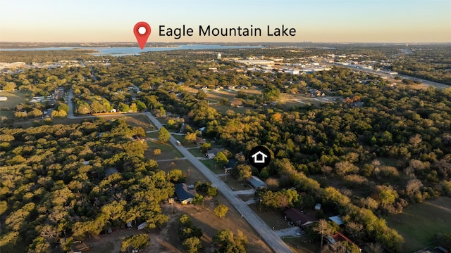 aerial view at dusk featuring a water view