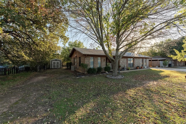 view of front of house featuring a front yard and a shed