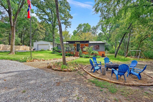 view of front of house featuring an outbuilding, a garage, a front lawn, and a porch