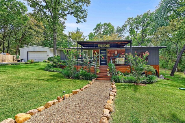 view of yard with an outbuilding, a garage, and a fire pit