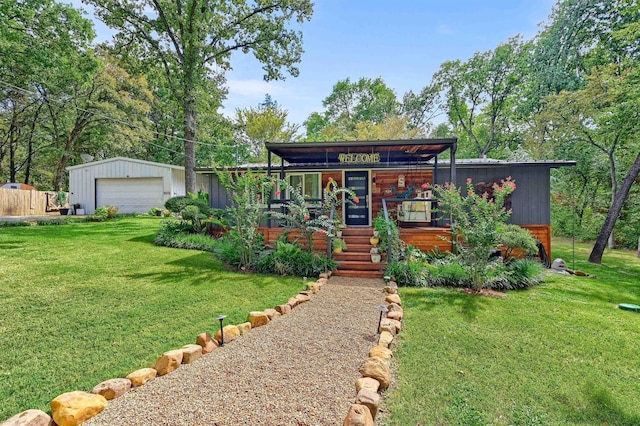 view of front of house featuring a garage, a front lawn, a porch, and an outdoor structure