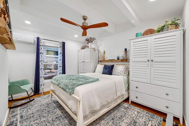 bedroom featuring recessed lighting, beam ceiling, a wall mounted air conditioner, and wood finished floors