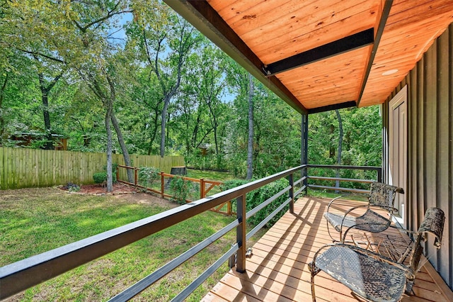 wooden deck featuring a lawn