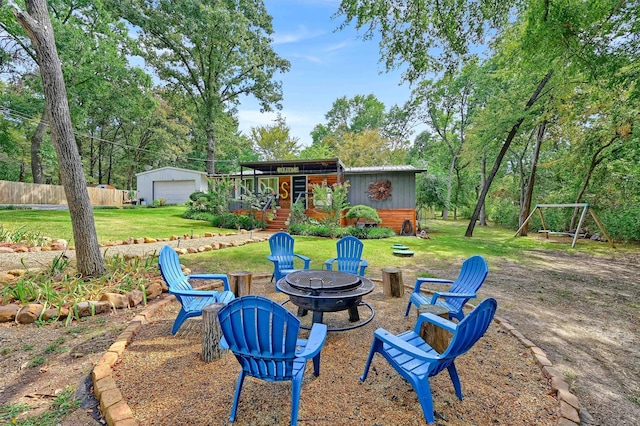 view of yard with an outdoor structure and an outdoor fire pit