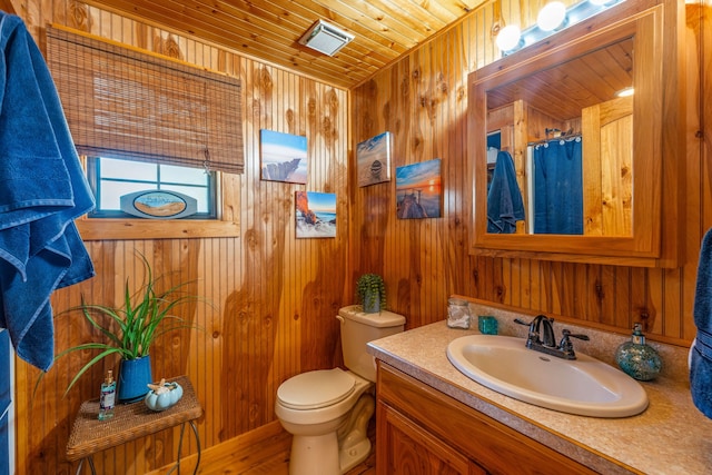 bathroom featuring vanity, wood walls, hardwood / wood-style floors, toilet, and wooden ceiling