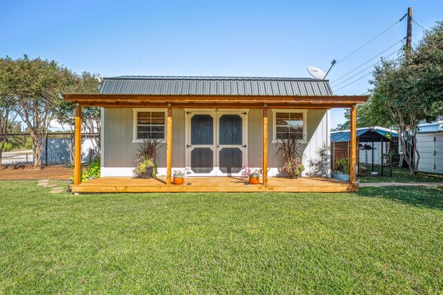 view of front facade featuring a front yard and a shed