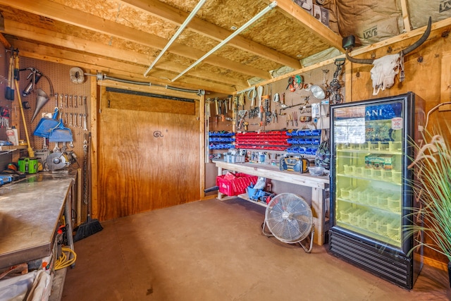 miscellaneous room featuring a workshop area and concrete floors