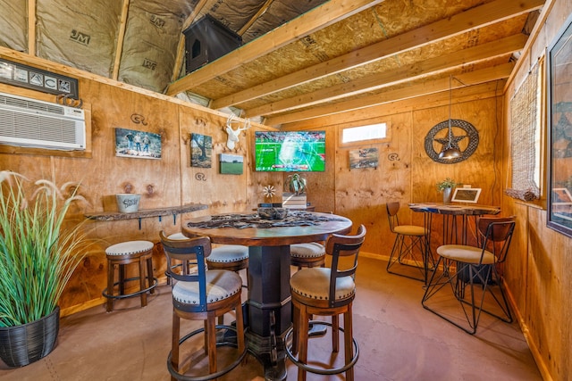 dining room featuring wood walls