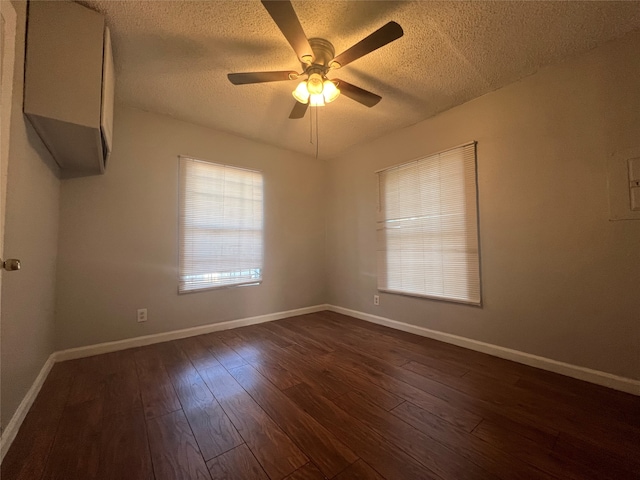 spare room with a textured ceiling, dark hardwood / wood-style flooring, and ceiling fan