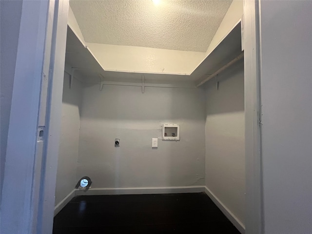 washroom with hookup for a washing machine, electric dryer hookup, and a textured ceiling