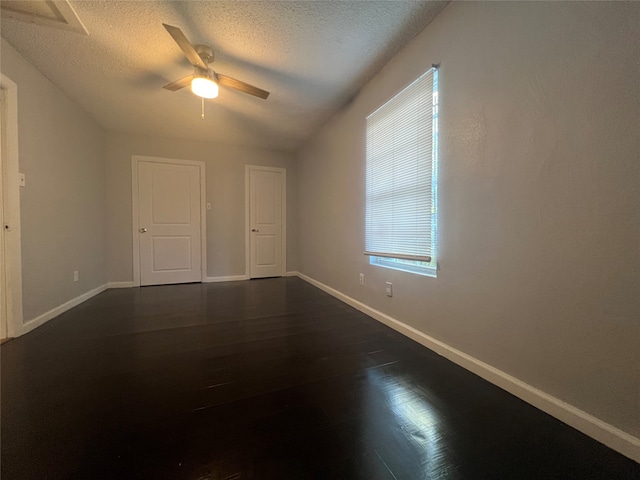 interior space featuring ceiling fan, a textured ceiling, and dark hardwood / wood-style floors