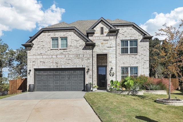 view of front of house featuring a front lawn and a garage