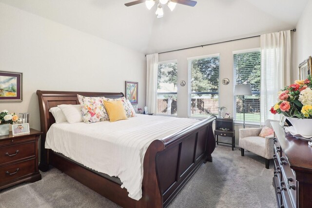 bedroom featuring lofted ceiling, light colored carpet, and ceiling fan