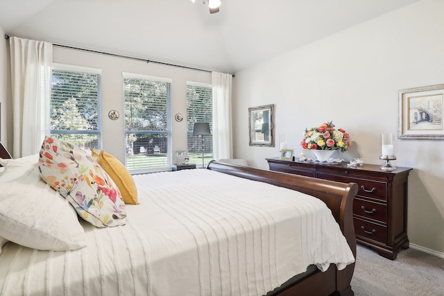 bedroom with ceiling fan, light carpet, and vaulted ceiling