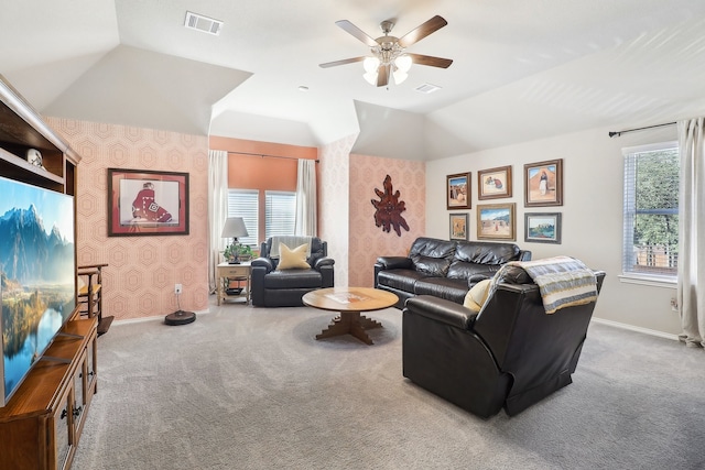 living room with plenty of natural light, vaulted ceiling, and carpet floors