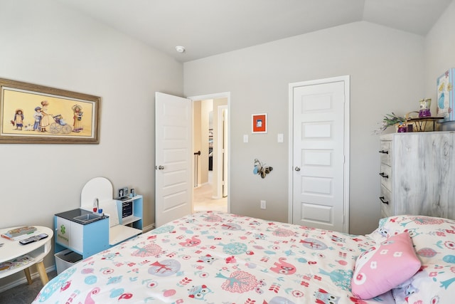 carpeted bedroom featuring lofted ceiling