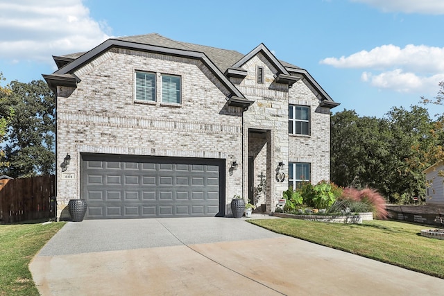 view of front of house featuring a front lawn and a garage