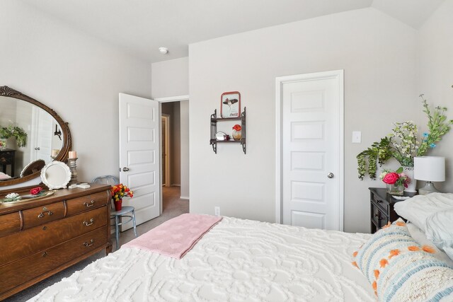 carpeted bedroom featuring lofted ceiling