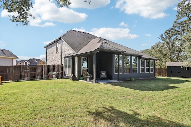 rear view of property featuring a yard