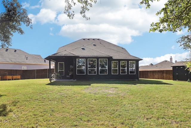 back of property with a yard and a patio area