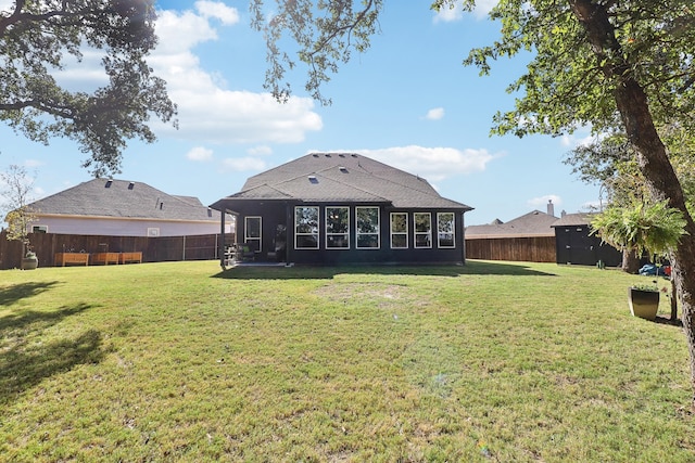 rear view of house with a yard