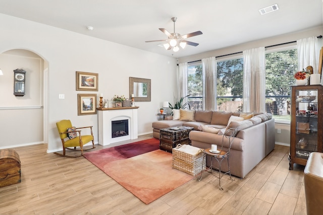 living room featuring ceiling fan and light hardwood / wood-style floors