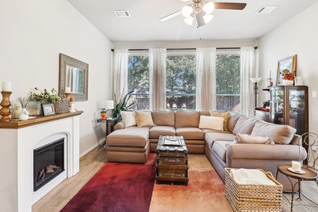 living room with light hardwood / wood-style floors and ceiling fan