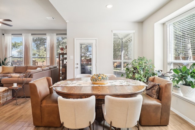 dining space with light wood-type flooring and ceiling fan