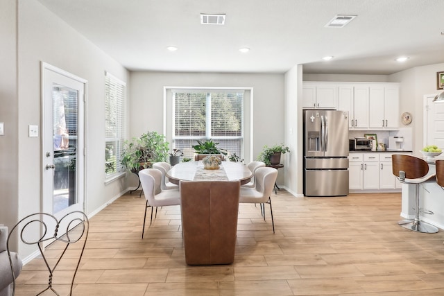 dining area featuring light wood-type flooring