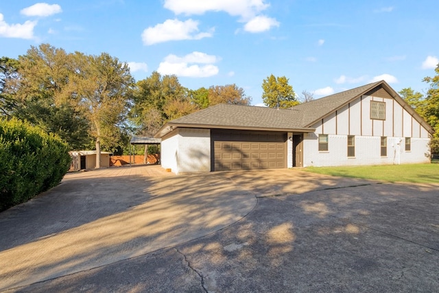 view of side of property featuring a shed and a garage