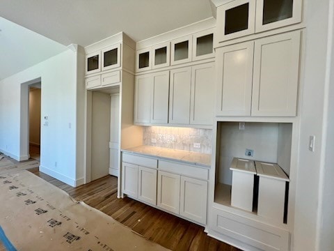 kitchen with decorative backsplash, white cabinets, and dark wood-type flooring